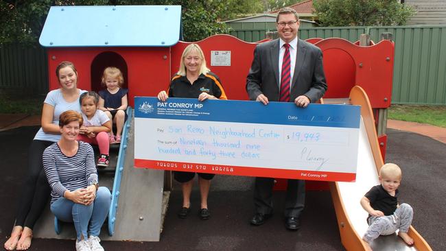 Labor MP Pat Conroy poses with constituents and a cheque for almost $20,000 in his federal seat of Shortland.