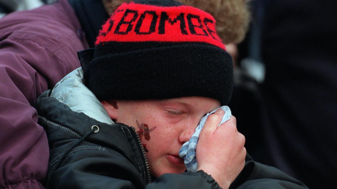 SEPTEMBER 18, 1999 : Young Bomber fan wipes away his tears after Essendon was defeated in AFL preliminary final clash against Carlton 18/09/99. Pic Michael Dodge.Australian Rules / Fans