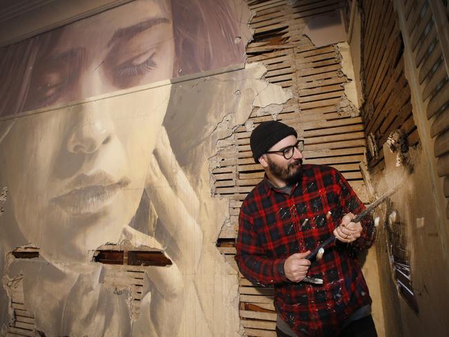 An abandoned house on the former AMCOR site at Alphington has been converted into a temporary art gallery by artist Rone. Rone uses a crow bar as well as paint and brushes to create his temporary art in abandon houses.   Picture: David Caird