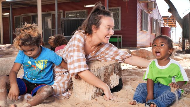 Indulkana Anangu School early childhood teacher Nikki Press with Michael and Kanuke. Picture: Dean Martin