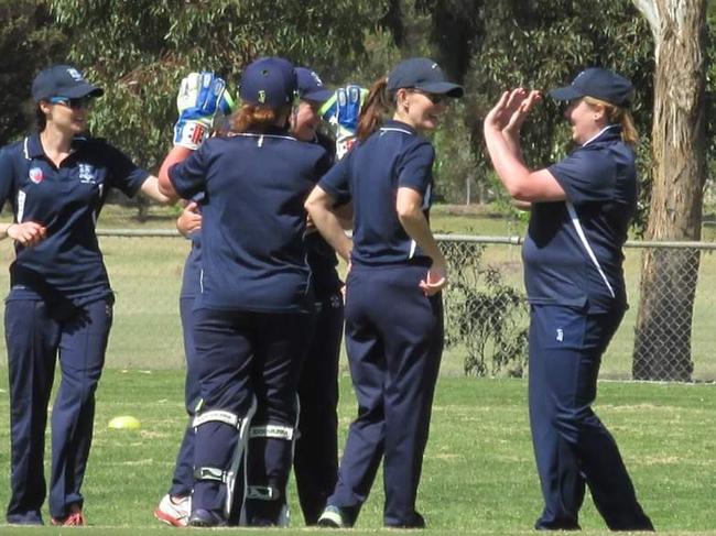 Holy Trinity players celebrate a wicket in the field.