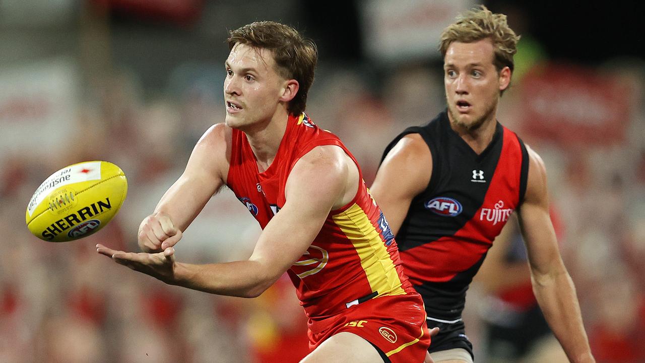 AFL Round 11. Gold Coast Suns vs Essendon at Metricon Stadium, Gold Coast.12/08/2020. Noah Anderson of the Suns clears infant of Darcy Parish of the Bombers . Pic: Michael Klein