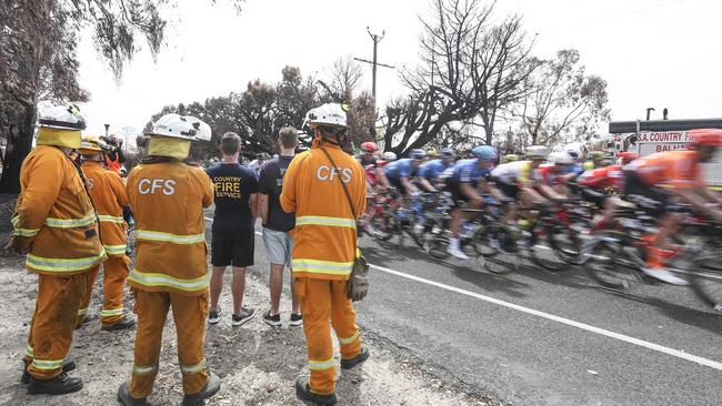 CFS volunteers watch the race briefly in Woodside before heading off to put out more spot fires. Picture: Sarah Reed