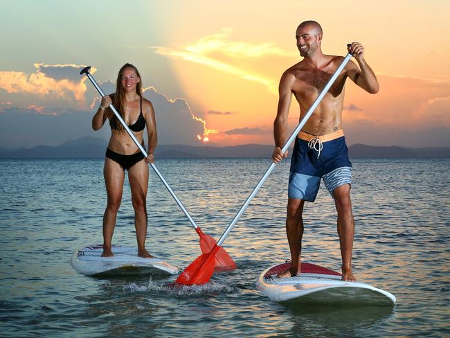 Ana Pestotnik and Alessandro Fici paddleboarding near Great Keppel Island Hideaway. Picture: Liam Kidston