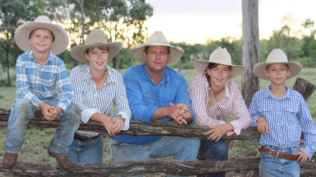 Staking a claim: Blair Angus, centre, with children David, Madelaine, Lauren and John. Below, cattle take a drink at a local river. The family’s two properties are a seven-hour drive apart.