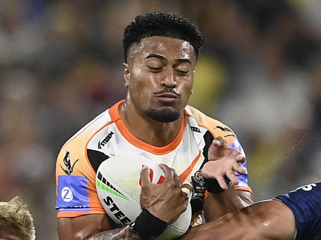 TOWNSVILLE, AUSTRALIA - MAY 24: Fonua Pole of the Tigers is tackled during the round 12 NRL match between North Queensland Cowboys and Wests Tigers at Qld Country Bank Stadium, on May 24, 2024, in Townsville, Australia. (Photo by Ian Hitchcock/Getty Images)