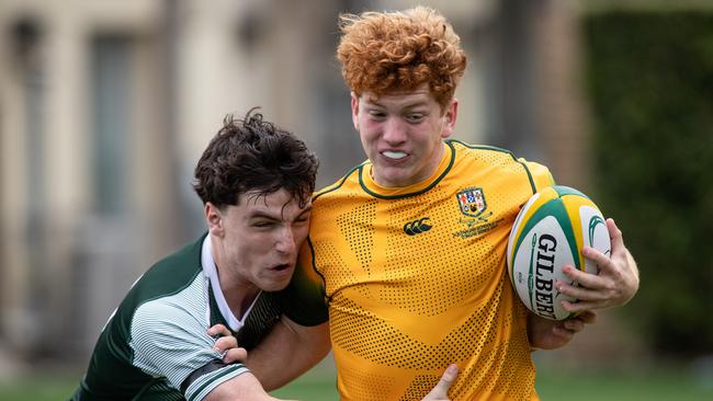 Australia’s Oscar Lane tackled by Barbarian gun Joseph Harvey. Picture: Julian Andrews