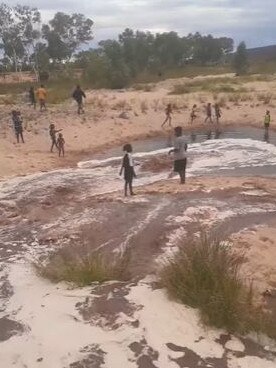 Ntaria (Hermannsburg) residents enjoying the Finke River flowing. Picture: Nick Ortyan