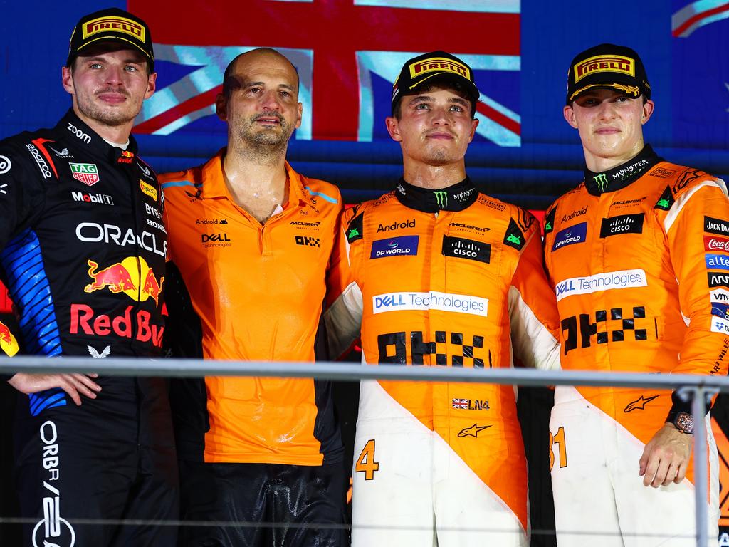 Race winner Lando Norris (second from right, Max Verstappen (left) and Oscar Piastri (right) pose for a photo on the podium. Picture: Getty Images