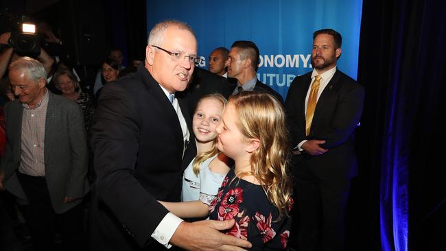 Prime Minister Scott Morrison hugs his daughters after Bill Shorten conceded. Picture: Hollie Adams