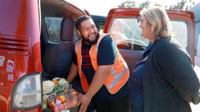 Volunteer Malachi Heka helps with the food delivery.