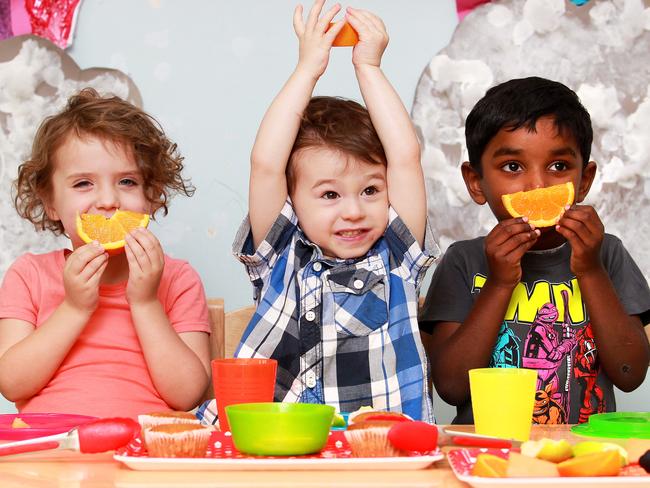 Jack Geneve-Clayer (centre) eats morning tea with his friends Vihaan Narahari and Lucy Wickham. Jack has egg, nut, soy and milk and dairy allergies. West end Community Childcare Centre has a strict no nut policy and requests that parents refrain from feeding their children nut products before attending the centre. Photo: Claudia Baxter