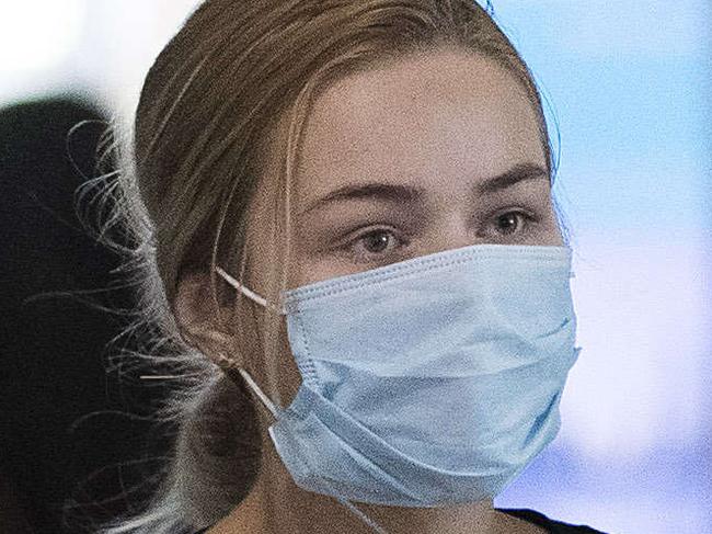 People arriving from asian countries wearing masks at the International airport. Brisbane International Airport, 29th of January 2020. (AAP Image/Attila Csaszar)