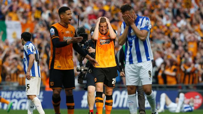Hull City's English defender Michael Dawson (C) reacts after Hull City won last year.