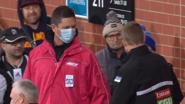 Nathan Buckley's fist pump with a spectator at Adelaide Oval.