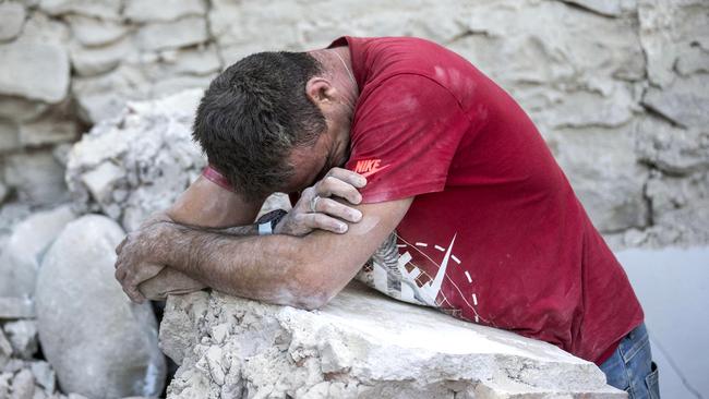 A man weeps among rubble in devastated Amatrice. Picture: Massimo Percossi/ANSA via AP