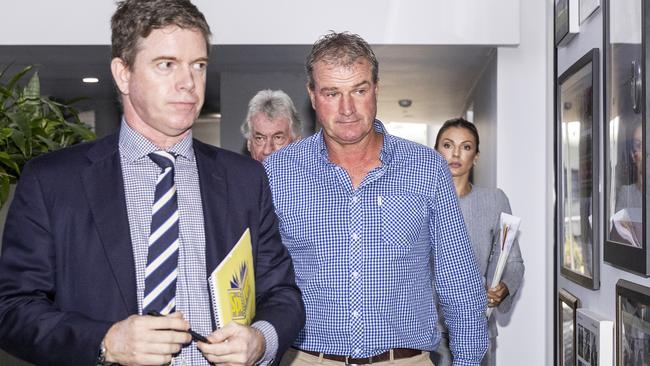 Darren Weir (centre) leaves the Victorian Racing Club's headquarters in February.