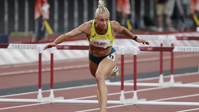 Liz Clay lunges on the line to finish third in her semi-final of the women’s 100m hurdles. . Picture: Alex Coppel. .