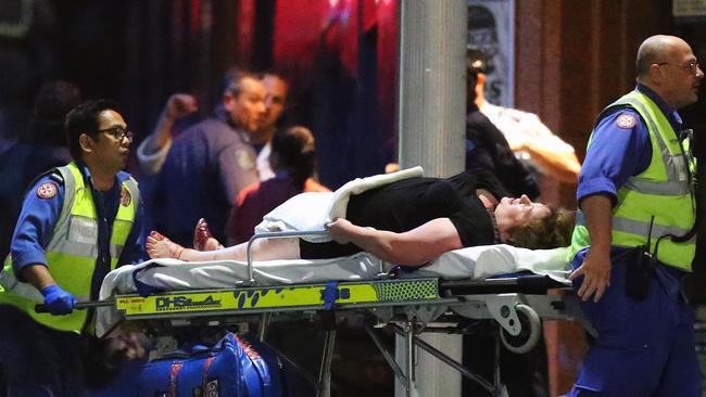 Hostage Louisa Hope is taken out of the Lindt Cafe by stretcher. Picture: Joosep Martinson/Getty Images