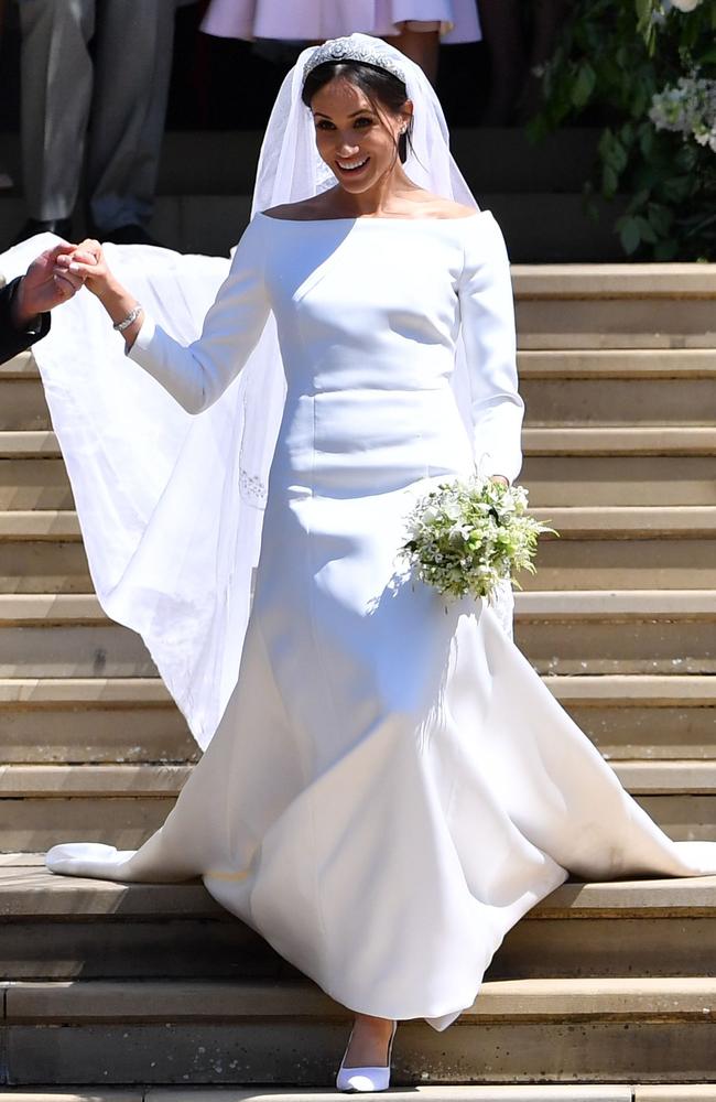 Britain's Prince Harry, Duke of Sussex and his wife Meghan, Duchess of Sussex emerge from the West Door of St George's Chapel, Windsor Castle, in Windsor, on May 19, 2018 after their wedding ceremony. Picture: AFP PHOTO / POOL / Ben STANSALL