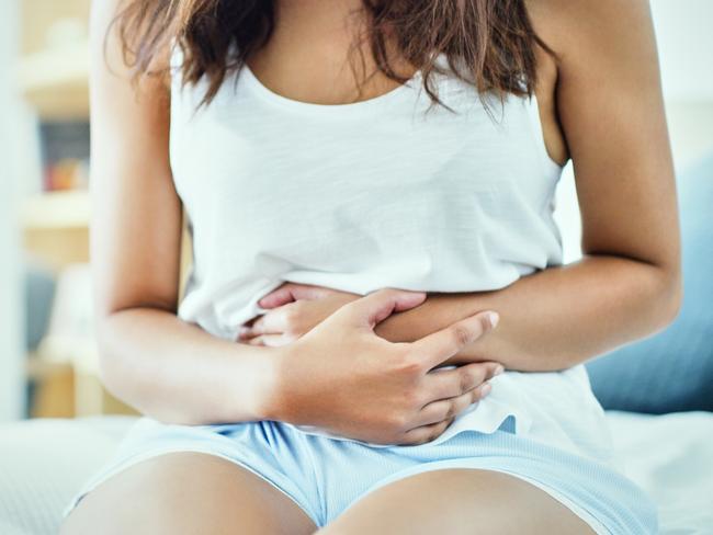 Shot of an unrecognizable woman suffering from stomach cramps in her bedroom  Picture: istock