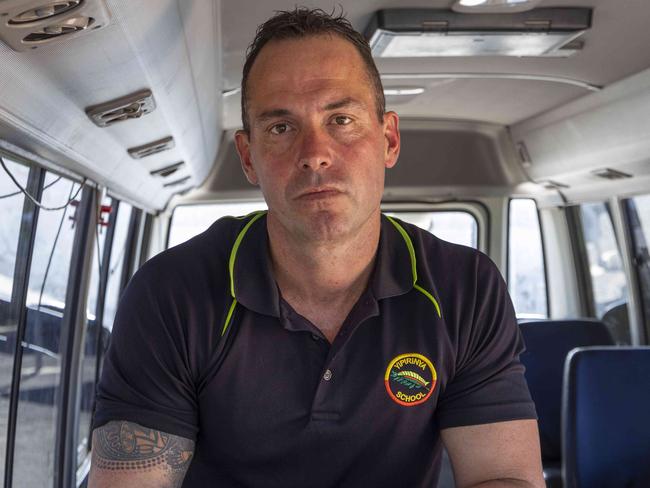 25/04/2023: Alice Springs based Yipirinya School principal Gavin Morris on the school grounds. He is with school minibuses similar to the one that was written off after a mob of students stole it in August 2022 for a joy-ride. PIC: Grenville Turner