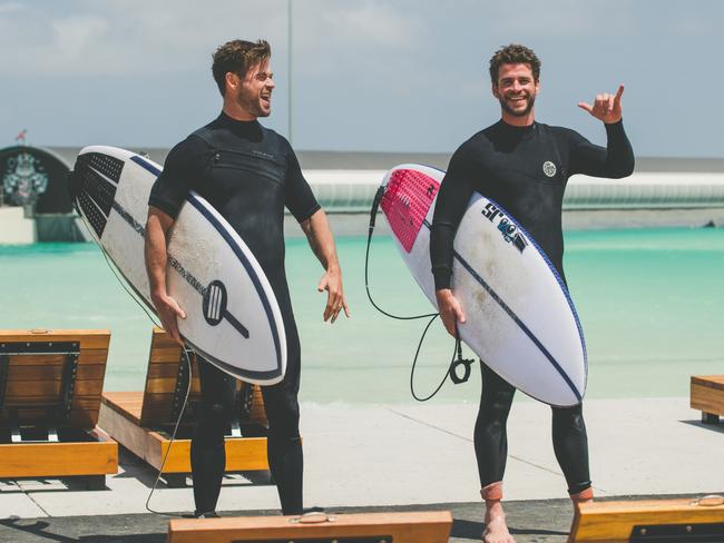 Chris and Liam Hemsworth surf at URBNSURF in Tullamarine. Picture: URBNSURF