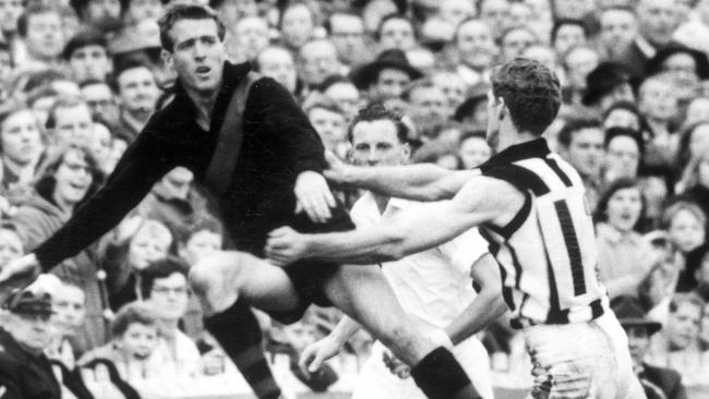 John Birt has a flying shot at gold during the 1965 preliminary final.