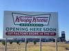 They’re Coming! Up goes the Krispy Kreme sign