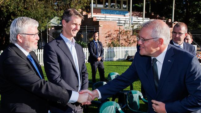 Former prime minister Kevin Rudd shakes hands with Scott Morrison at Eid prayers in Parramatta. Picture: Jason Edwards