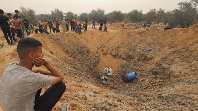 Palestinians gather around a huge crater following overnight Israeli bombardment in Rafah in the southern Gaza Strip. Picture: AFP