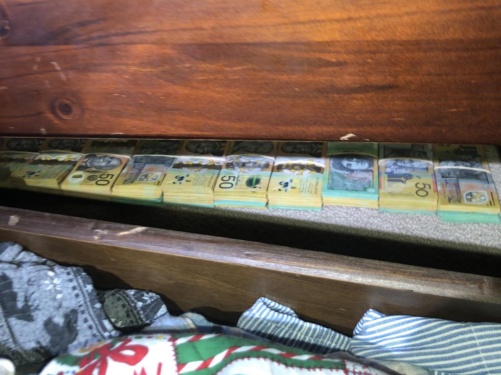 Wads of cash were lined up in a clothes draw. Picture: AFP