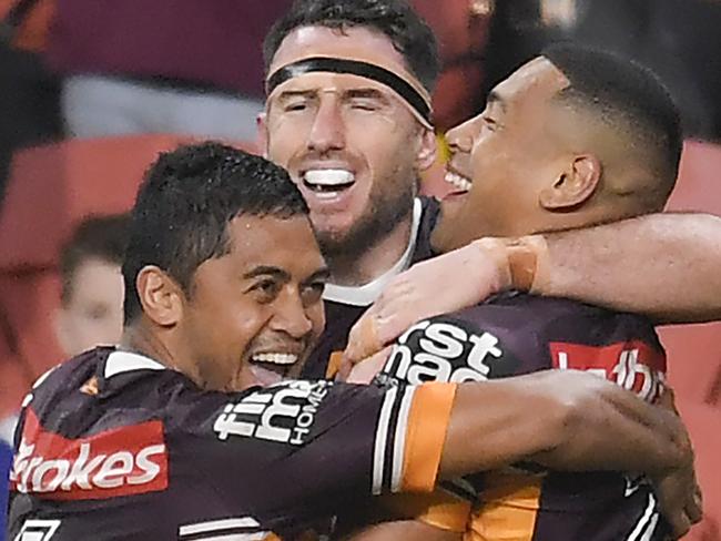 BRISBANE, AUSTRALIA - JULY 11: Jamayne Isaako (right) of the Broncos celebrates with Darius Boyd (c) and Anthony Milford after scoring a try during the round nine NRL match between the Brisbane Broncos and the Canterbury Bulldogs at Suncorp Stadium on July 11, 2020 in Brisbane, Australia. (Photo by Albert Perez/Getty Images)