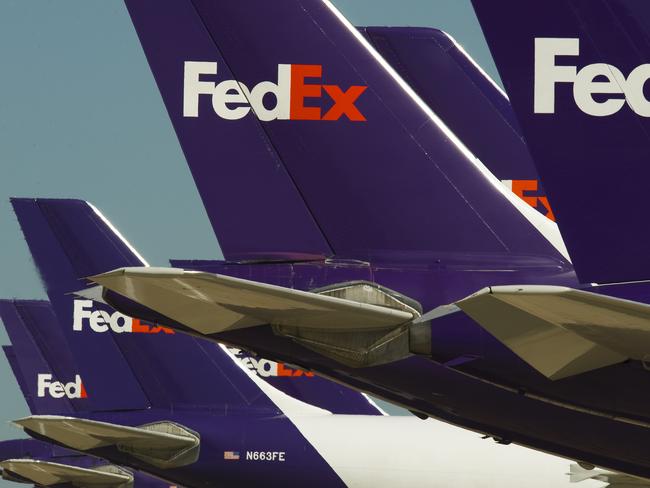 (FILES)Federal Express cargo jets are lined up at the Memphis, Tennessee, headquarters World Hub, where aircraft wait to be loaded with packages and documents. - A FedEx pilot was arrested in China and released on bail, the company said September 19, 2019, amid an ongoing row with Beijing over the US firm's delivery irregularities  involving telecoms giant Huawei. Todd Hohn, a former US Air Force pilot, was arrested by Chinese authorities a week ago as he waited for a commercial flight in the company's Asia hub of Guangzhou, after making a round of deliveries. (Photo by Paul J. RICHARDS / AFP)