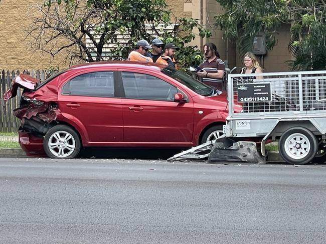 The rear of a red sedan sustained significant damage as a result of the crash. Picture: Fergus Gregg.