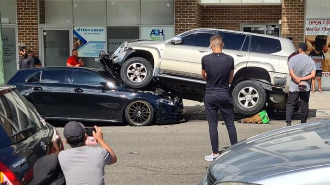 An SUV ended up on top of a black hatchback at a multi-vehicle accident on Helen St, Sefton. Picture: Supplied