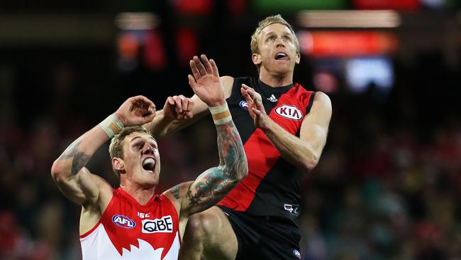 Tim Membrey vies with Essendon veteran Dustin Fletcher in a marking contest.