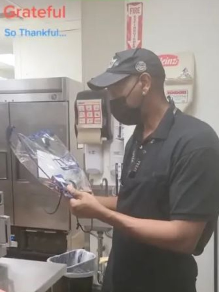 For his 27 year anniversary at Burger King, Ford was handed a backpack with a movie ticket, a Starbucks cup and a mix of candy and chocolate. Picture: TikTok/thekeep777