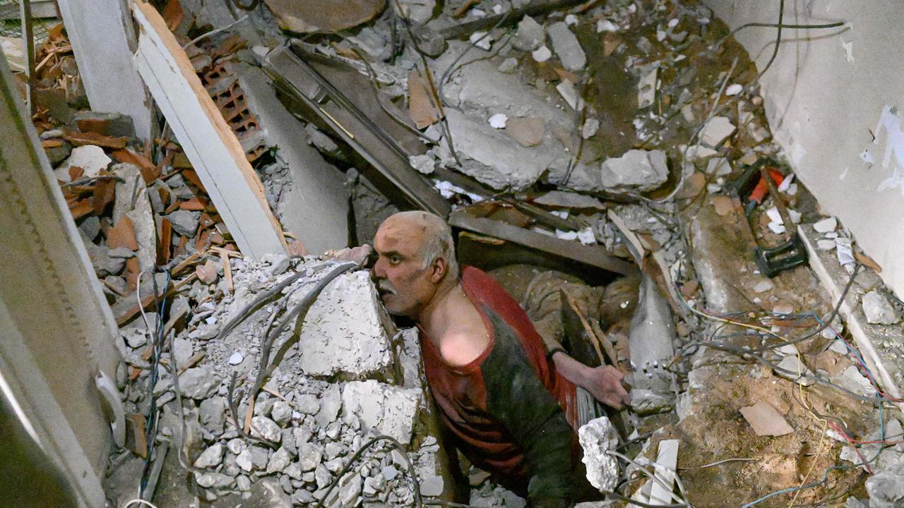 A man trapped in rubble reacts while debris is removed to work on is rescue in Hatay, Turkey.Picture: Bulent Kilic/AFP