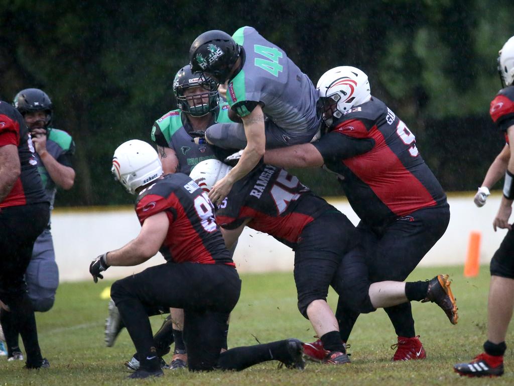 Angus Ramsay sends a Cairns Falcons runner airborne with a trademark tackle. PICTURE: ANNA ROGERS