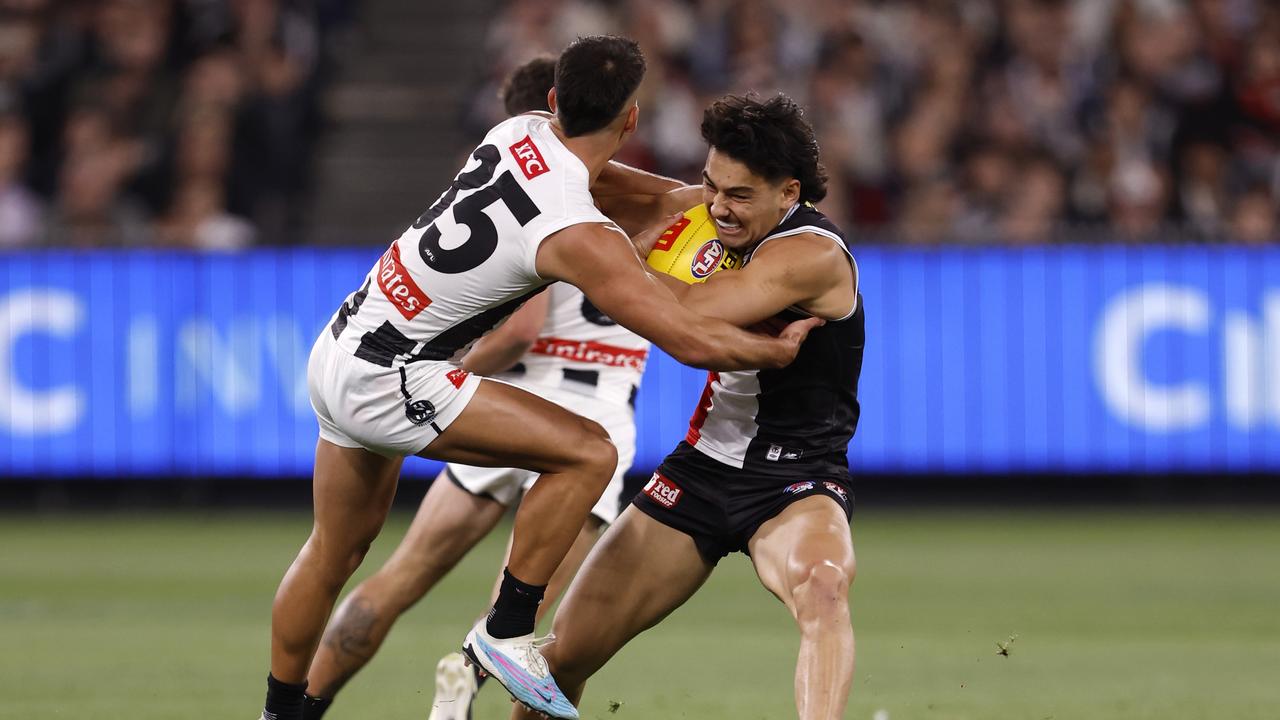 Mitch Owens fends of Nick Daicos. Photo by Darrian Traynor/Getty Images.