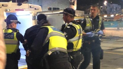 A man is arrested near the corner of Flinders and Swanston streets overnight. Picture: Sophie Welsh