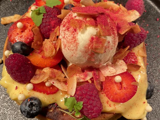 Smolt's indulgent Berry and White Chocolate Hotcake is topped with fresh Tasmanian berries, vanilla ice cream, homemade lemon curd and a crunchy coconut crumb.