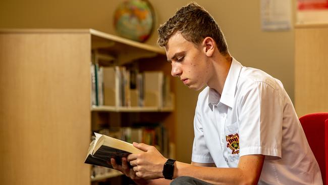 Cameron Last, 15, reading in the library at Marist College Eastwood. Picture: Monique Harmer