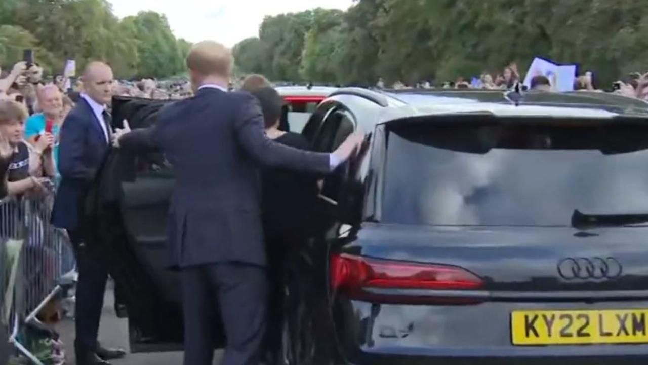 Harry holds the door open for his wife, ensuring she gets in safely …