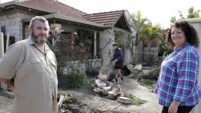 Frank and Marianne Cope of Rosewater survey the wreckage of their front yard after a ute lost control and ploughed through their fence. Picture Dean Martin