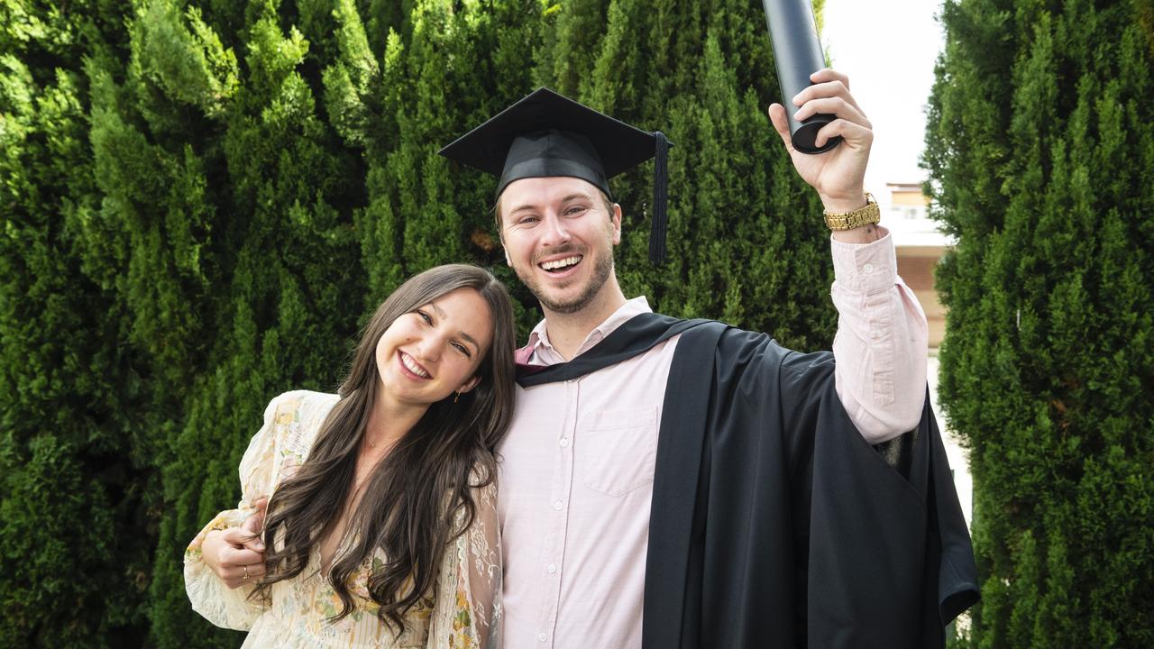 Bachelor of Spatial Science Technology graduate Jamie Quinn celebrates his degree with Ruby Carnes at the UniSQ graduation ceremony at Empire Theatres, Tuesday, December 13, 2022. Picture: Kevin Farmer