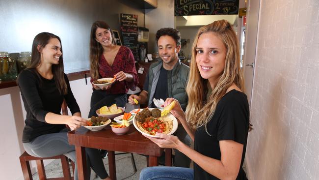 09/05/2019. (L-R) Daniela Pizzo, Augustina Aldabalde, Rafael Paris-Otto and Camila Jensen share hummus dishes at Simply Hummus Bar in Darlinghurst, Sydney's first dedicated hummus restaurant. Ahead of International hummus day. Britta Campion / The Australian