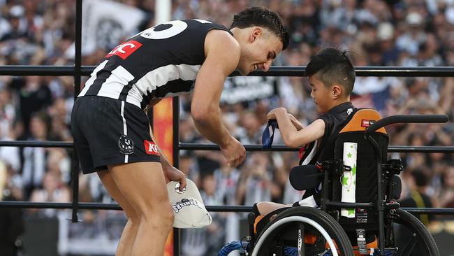 MELBOURNE , AUSTRALIA. September 30, 2023. AFL Grand Final between Collingwood and the Brisbane Lions at the MCG.   Nick Daicos of the Magpies receives his premiership medal  .Picture by Michael Klein