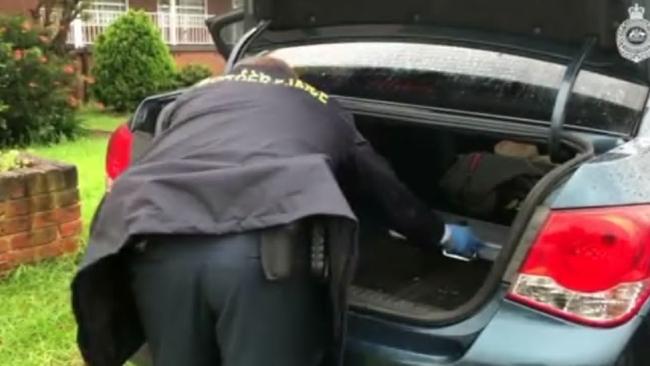 An ABF officer raids a vehicle at Hazelton’s home. Picture Australian Border Force